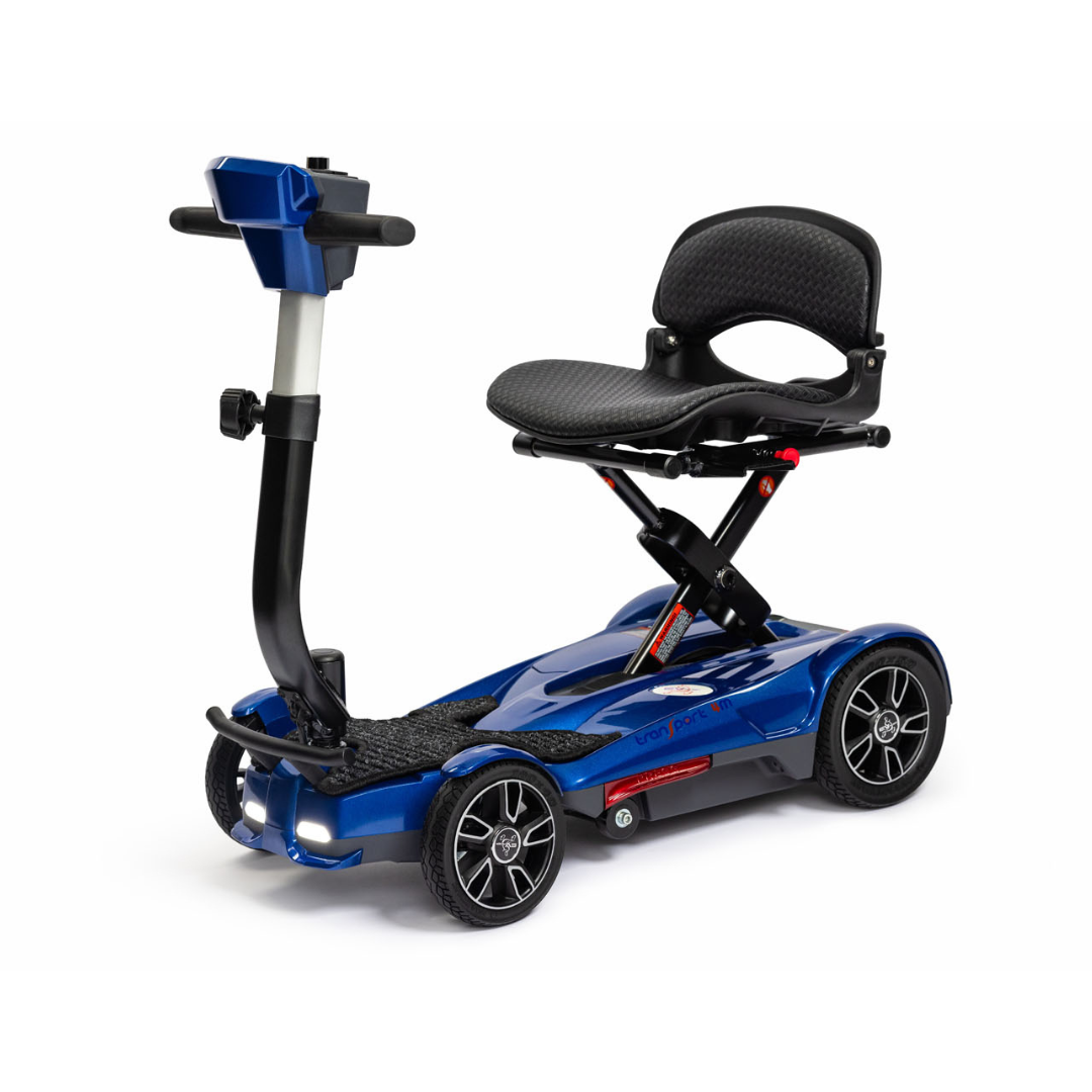 The EV Rider Transport 4M Travel Scooter is a compact, blue four-wheel scooter featuring a cushioned seat with backrest, adjustable steering column, and handlebar controls—airline-approved for hassle-free mobility while traveling.
